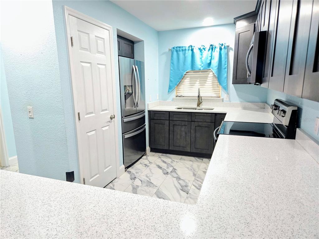 5943 Topher Trail, Unit 22 Mulberry, FL 33860 - Photo 4 of 15 a large bedroom with a large bed and wooden floor