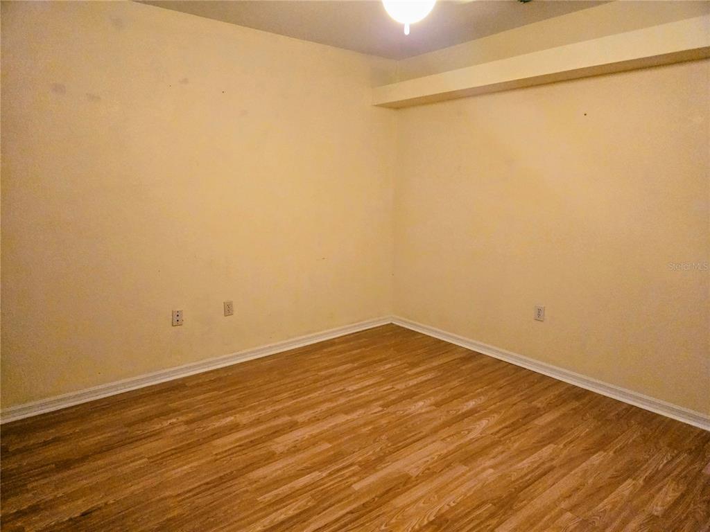 5943 Topher Trail, Unit 22 Mulberry, FL 33860 - Photo 9 of 15 a view of an empty room with wooden floor and a window
