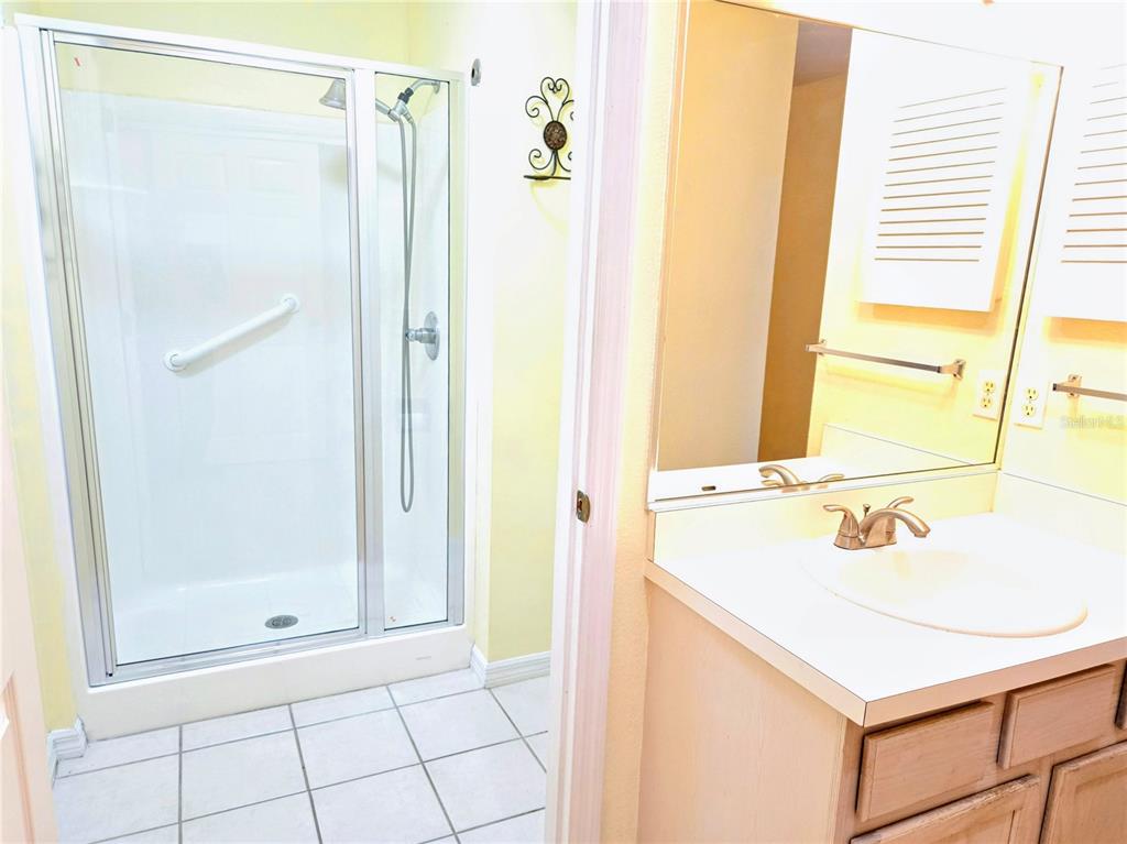 5943 Topher Trail, Unit 22 Mulberry, FL 33860 - Photo 10 of 15 a bathroom with a shower sink and a mirror
