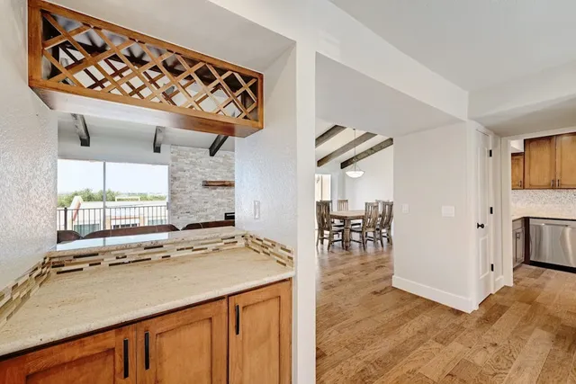 a room with stainless steel appliances kitchen island a chandelier