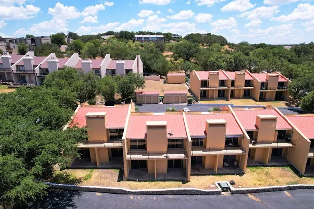 a aerial view of a large pool with lawn chairs