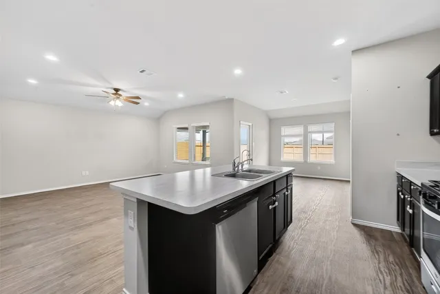 a kitchen with a sink appliances and cabinets