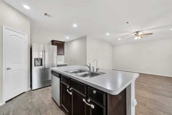 a kitchen with a stove a refrigerator and a sink