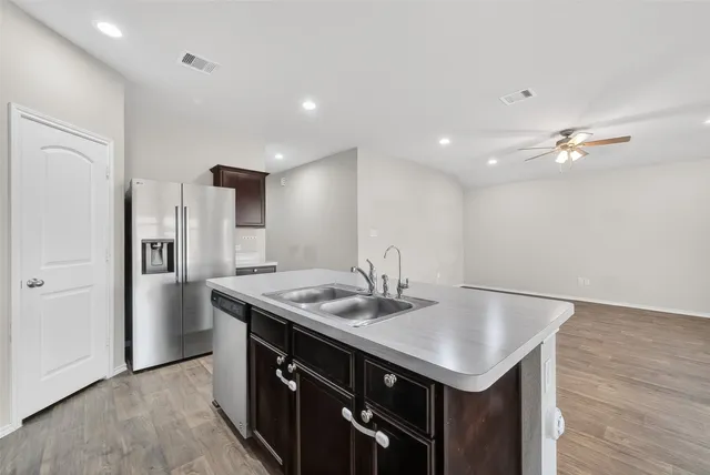 a kitchen with a stove a refrigerator and a sink