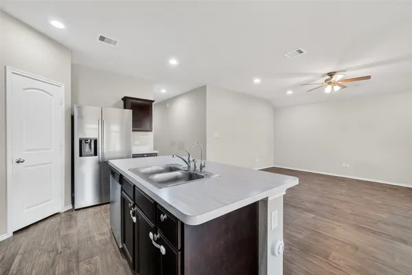a kitchen with a stove a sink and a refrigerator