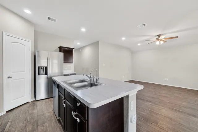 a kitchen with a stove a sink and a refrigerator