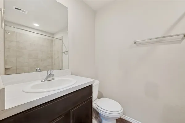 a bathroom with a sink toilet and a mirror