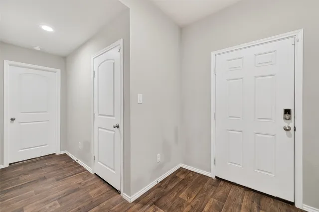 a view of a hallway with wooden floor
