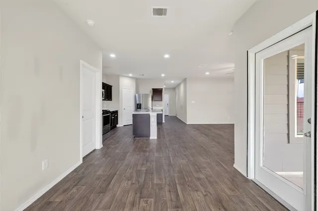 an empty room with fan and windows