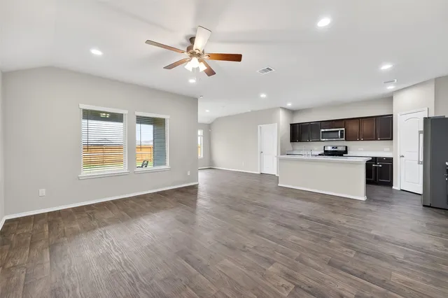a view of a kitchen with a microwave and a stove top oven