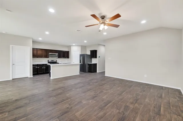 a view of a room with a window and a fan