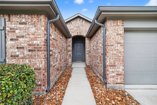 a view of entryway with a front door and wooden floor