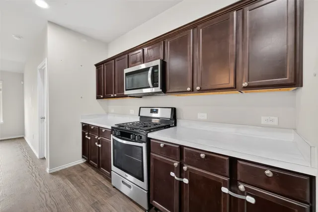 a kitchen with a sink stove and microwave