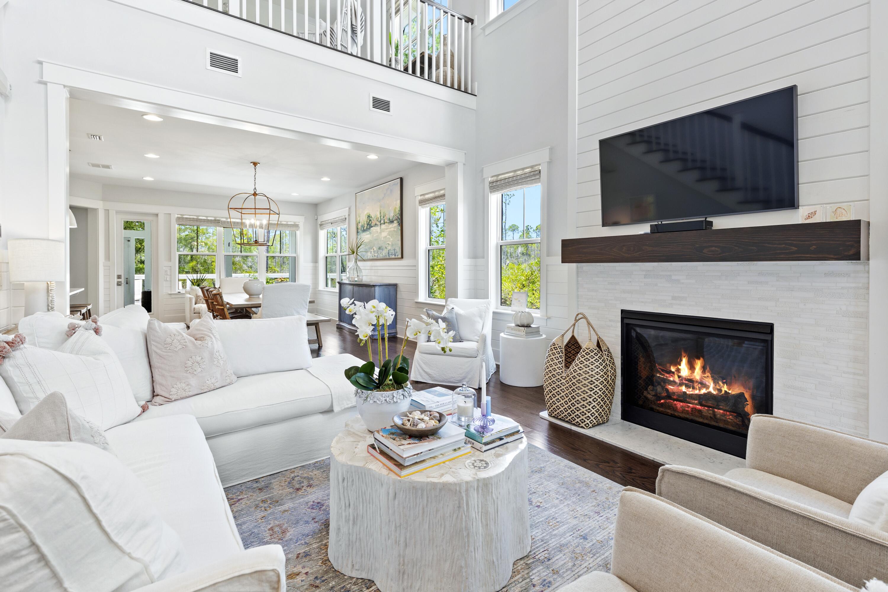 235 Prairie Pass Santa Rosa Beach, FL 32459 - Photo 12 of 80 a living room with furniture a flat screen tv and a fireplace