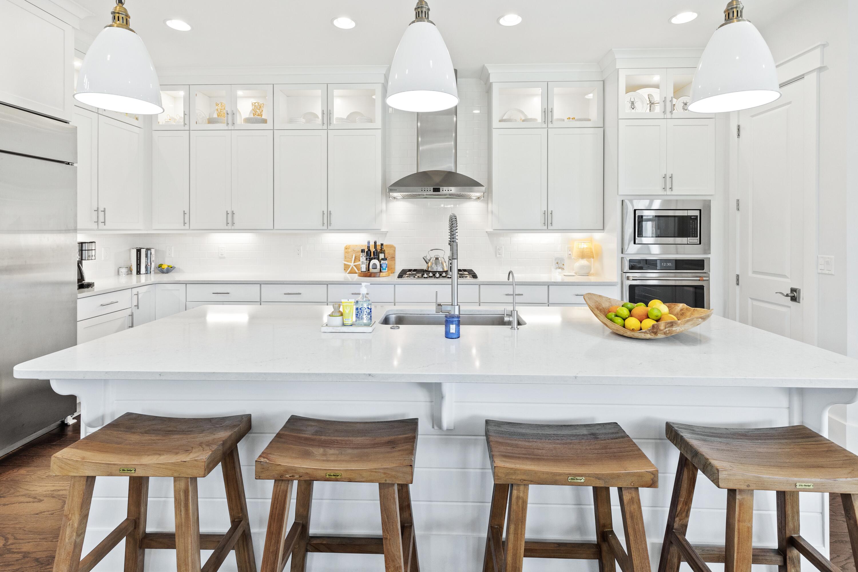 235 Prairie Pass Santa Rosa Beach, FL 32459 - Photo 17 of 80 a kitchen with a dining table chairs stove and white cabinets