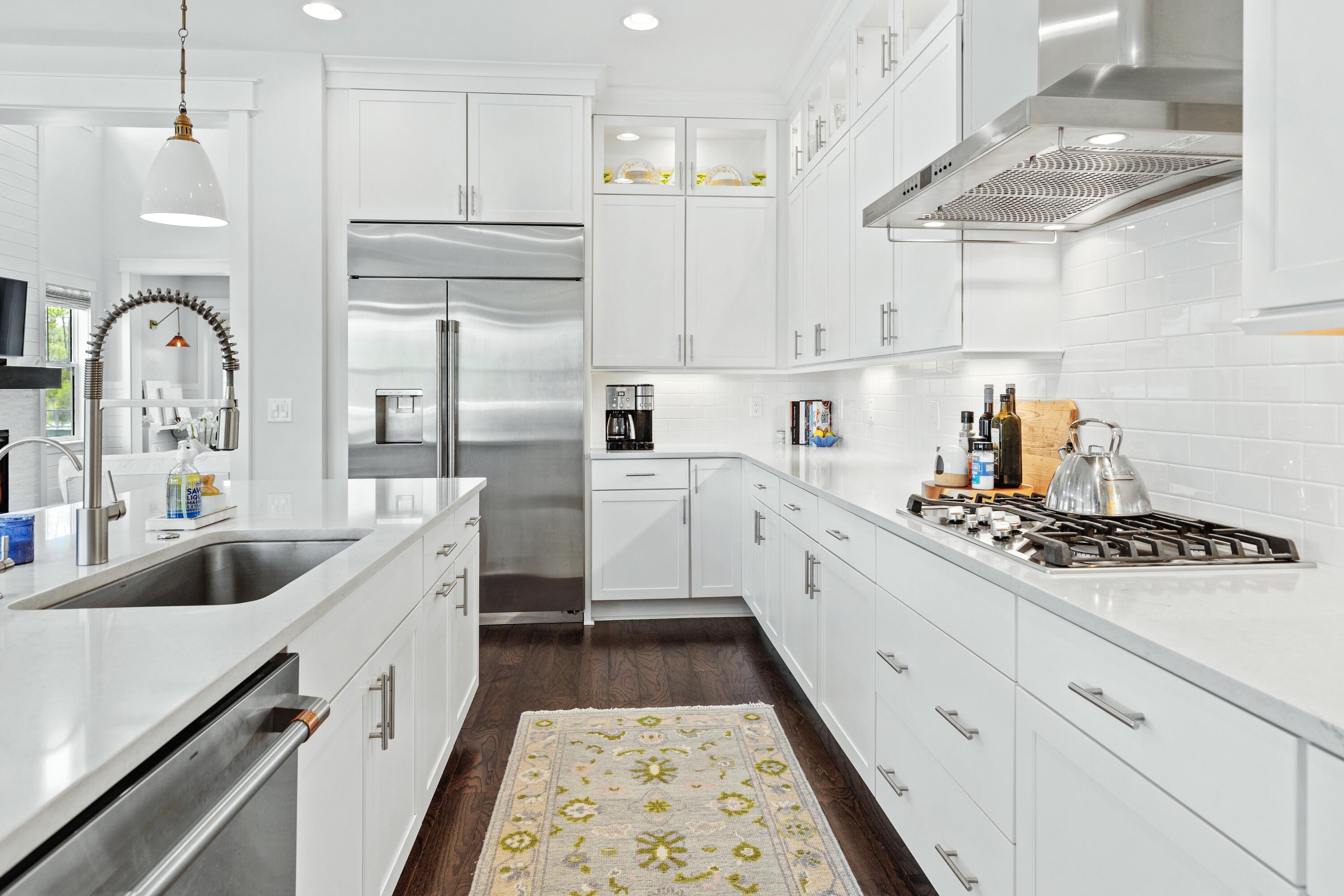 235 Prairie Pass Santa Rosa Beach, FL 32459 - Photo 19 of 80 a kitchen with white cabinets and sink