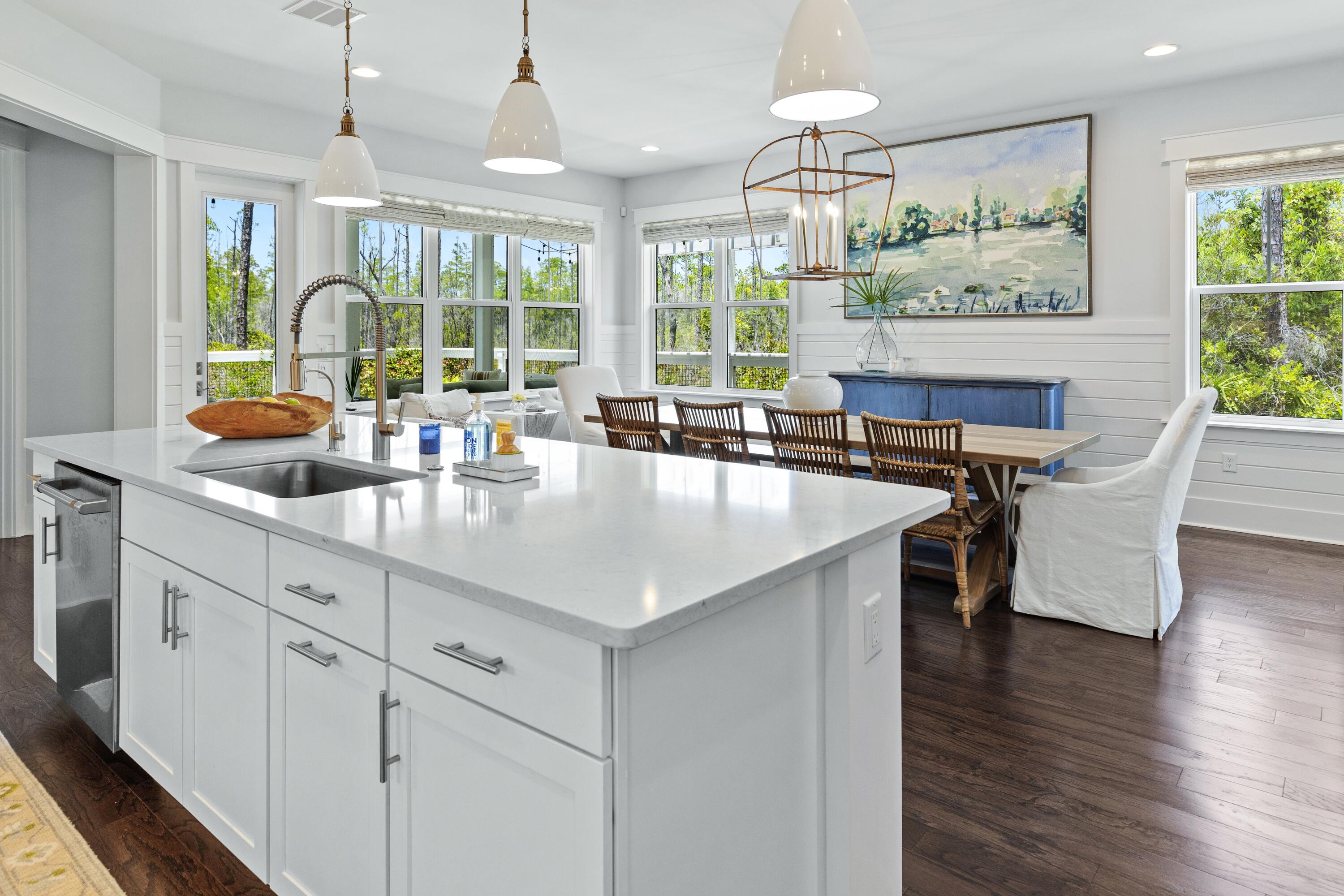 235 Prairie Pass Santa Rosa Beach, FL 32459 - Photo 20 of 80 a kitchen with stainless steel appliances granite countertop a table chairs and a chandelier