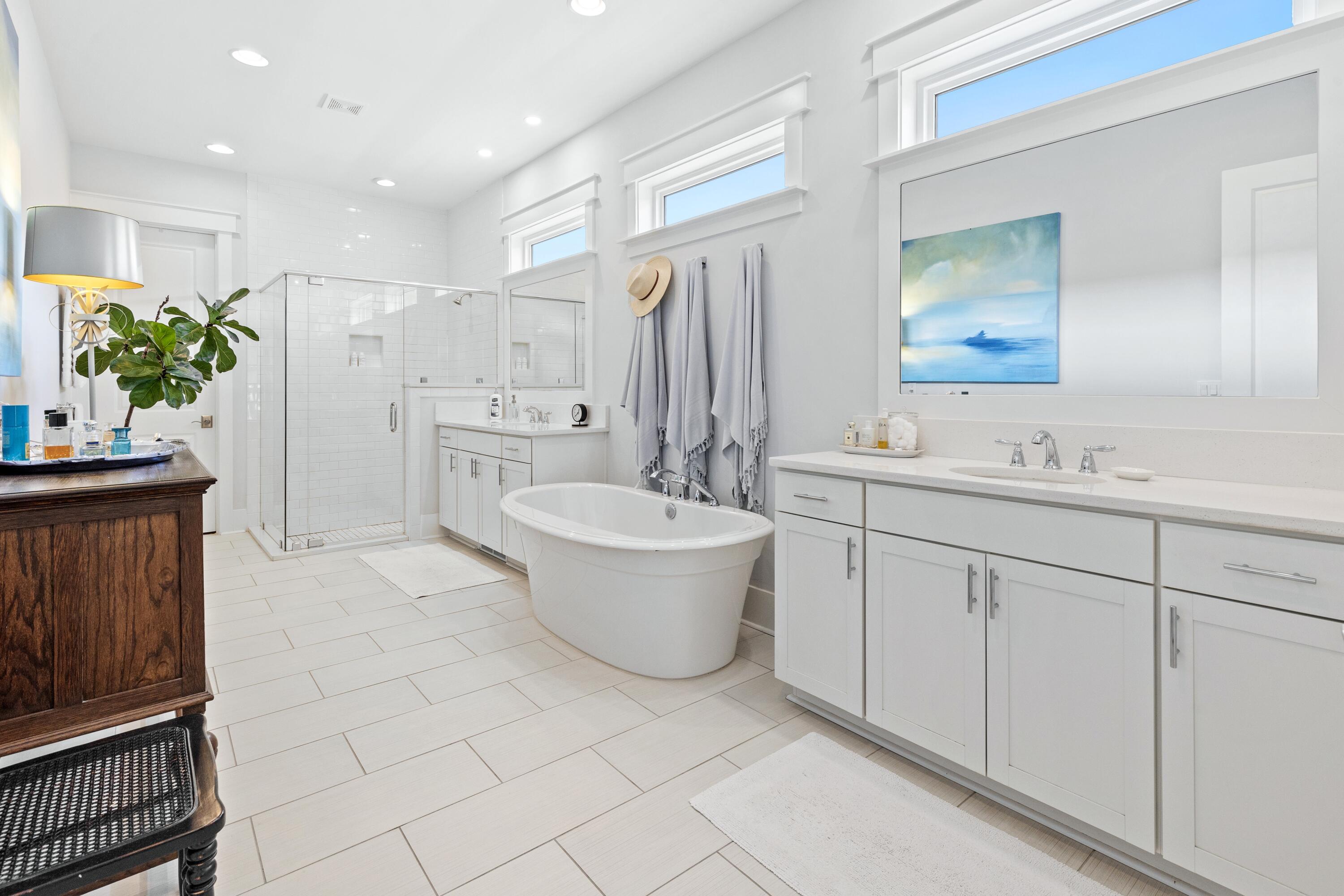 235 Prairie Pass Santa Rosa Beach, FL 32459 - Photo 22 of 80 a spacious bathroom with a double vanity sink a mirror a bathtub and next to a window