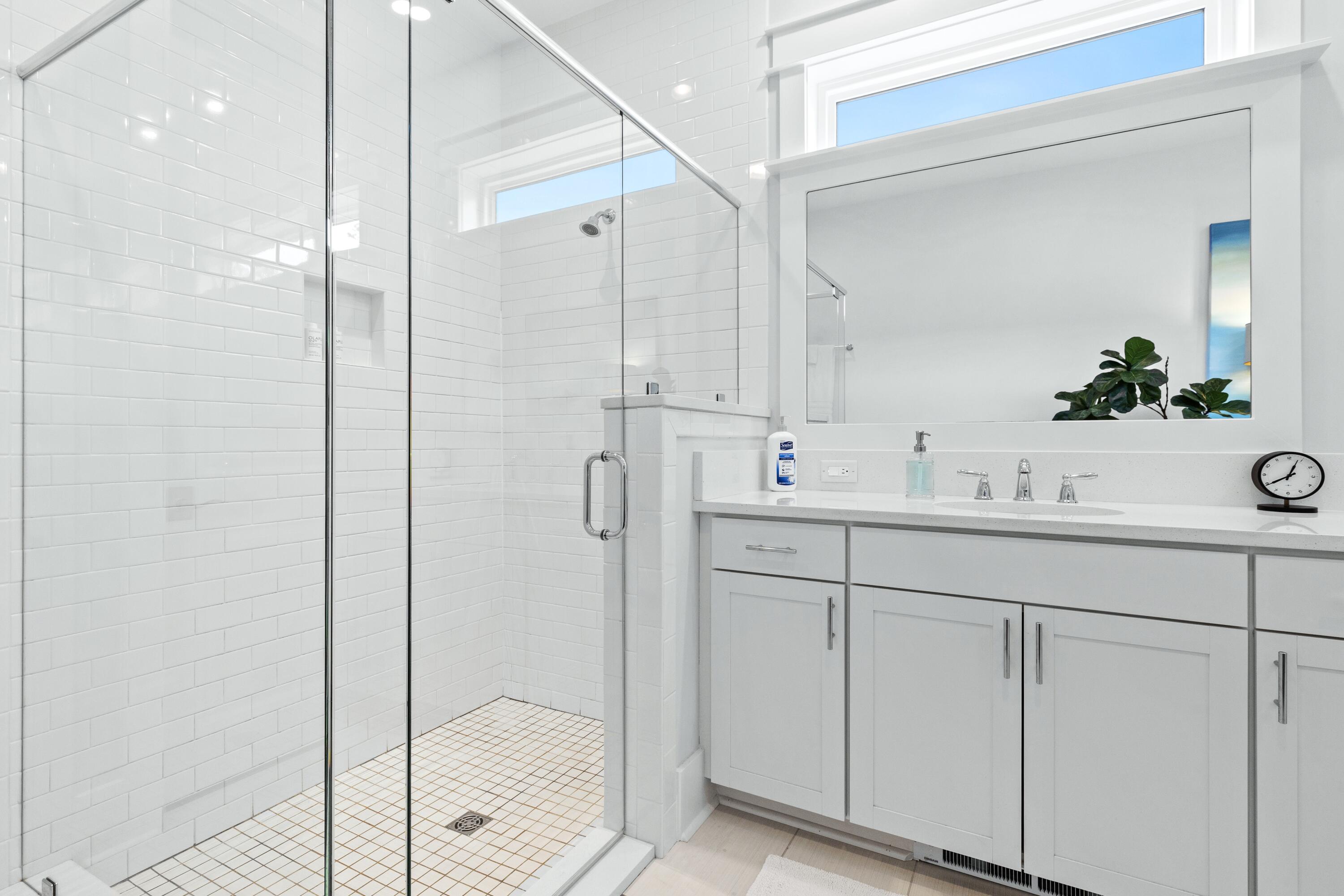 235 Prairie Pass Santa Rosa Beach, FL 32459 - Photo 24 of 80 a bathroom with a shower sink and mirror