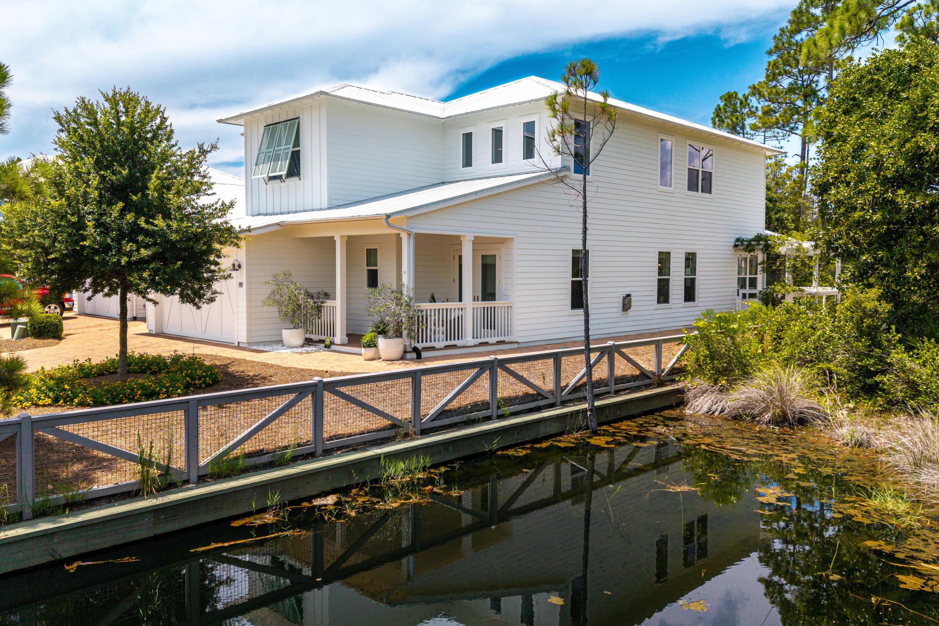 235 Prairie Pass Santa Rosa Beach, FL 32459 - Photo 6 of 80 a view of house with swimming pool and outdoor seating