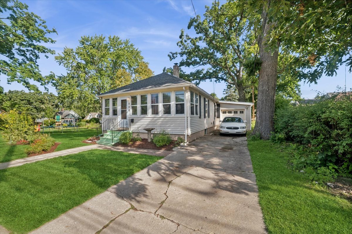 508 River Bluff Road Elgin, IL 60120 - Photo 12 of 17 a front view of a house with a garden and trees