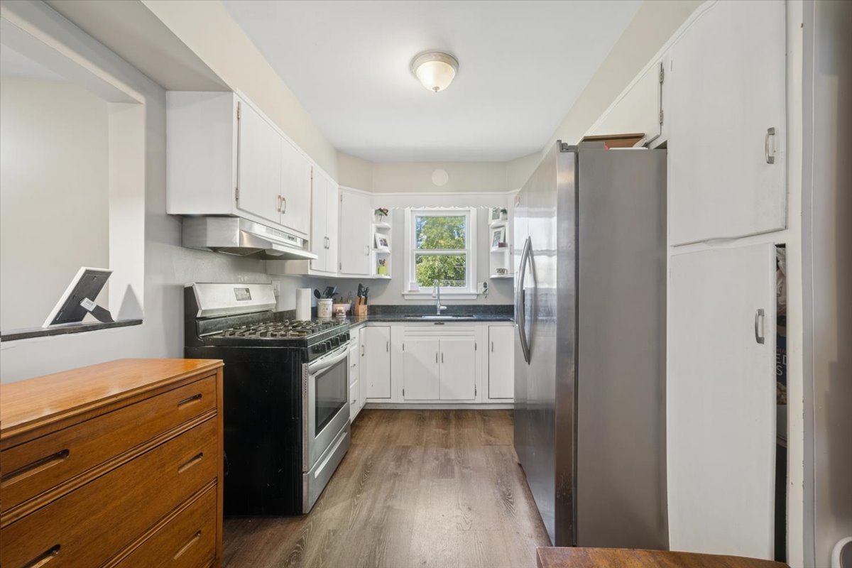508 River Bluff Road Elgin, IL 60120 - Photo 6 of 17 a kitchen with a refrigerator stove and white cabinets