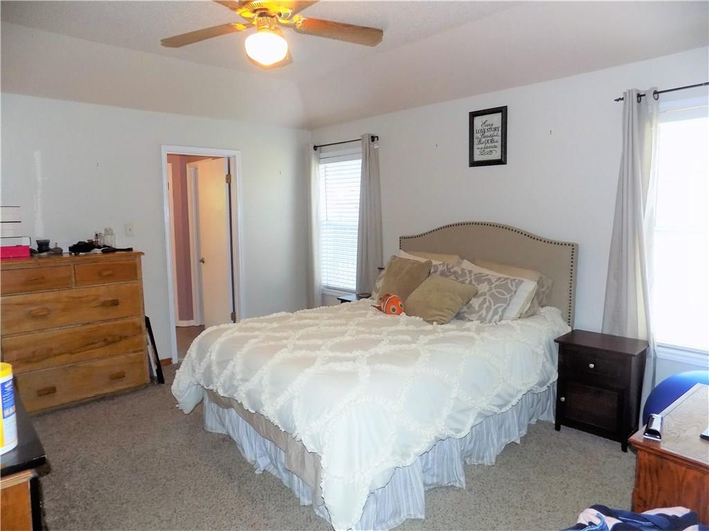 2306 Raintree Path Round Rock, TX 78664 - Photo 10 of 15 Carpeted bedroom featuring a ceiling fan with light fixture, two windows with blinds, and a neutral wall color