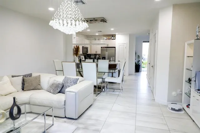 a living room with furniture and a chandelier