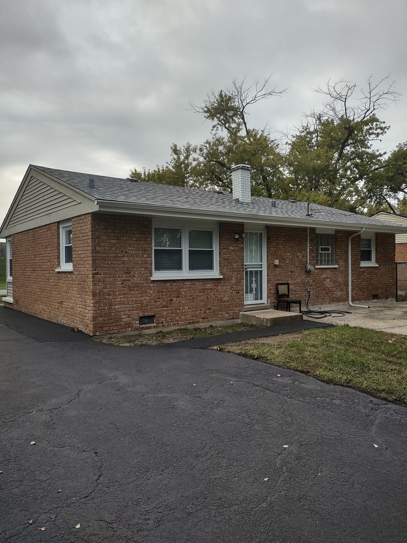 16549 California Avenue Markham, IL 60428 - Photo 13 of 14 a front view of a house with a garden
