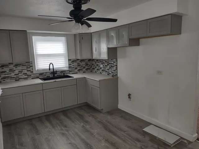 a kitchen with stainless steel appliances a sink stove and cabinets