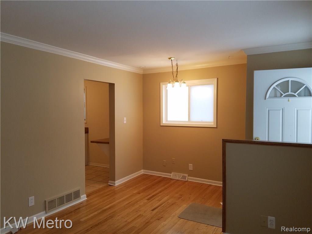 5265 Sashabaw Road Clarkston, MI 48346 - Photo 2 of 9 Spacious Living Room With Hardwood Floors