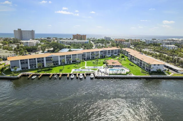an aerial view of a swimming pool with outdoor seating and city view