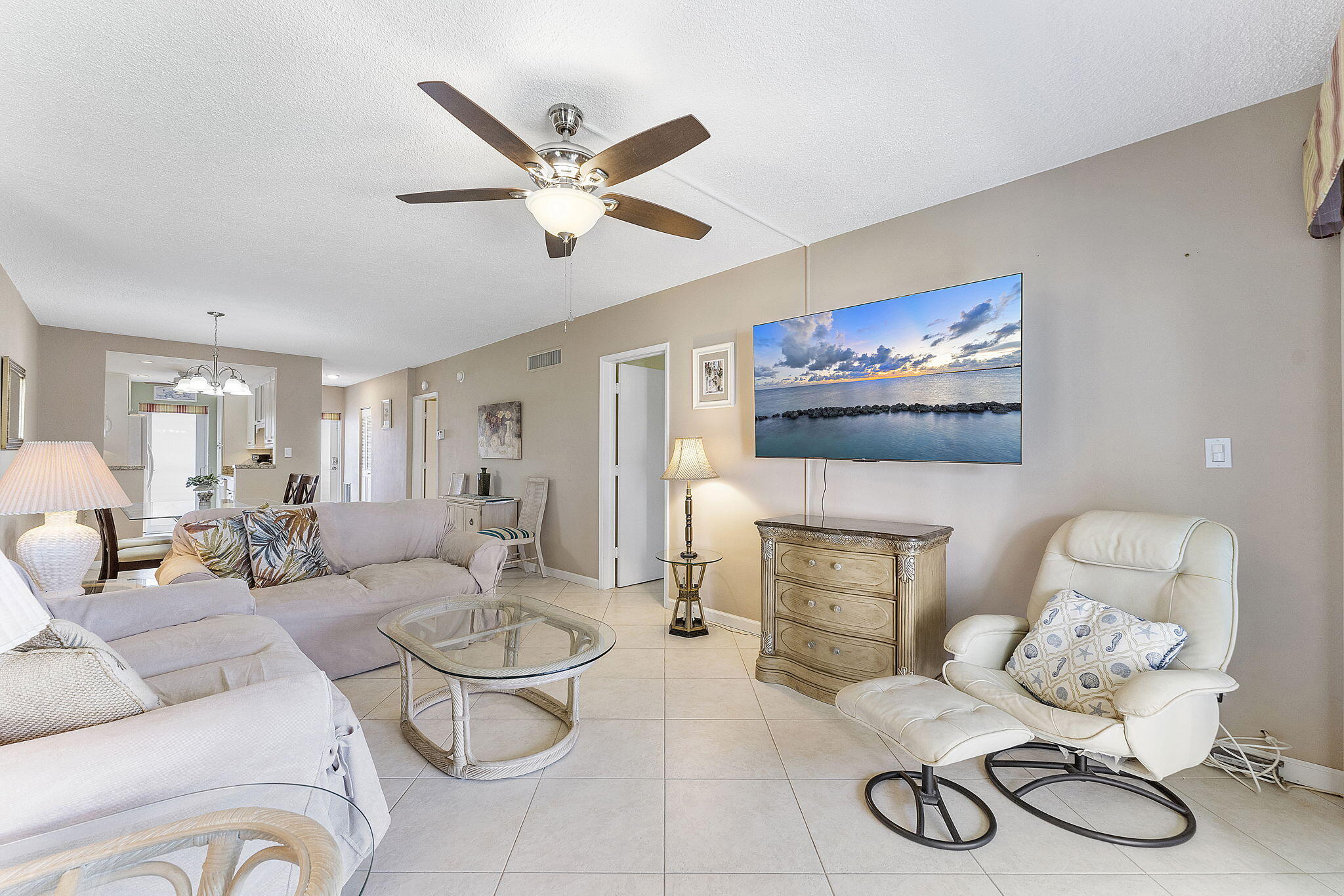 101 Northeast 19th Avenue, Unit 208 Deerfield Beach, FL 33441 - Photo 11 of 38 a living room with furniture a rug and white walls