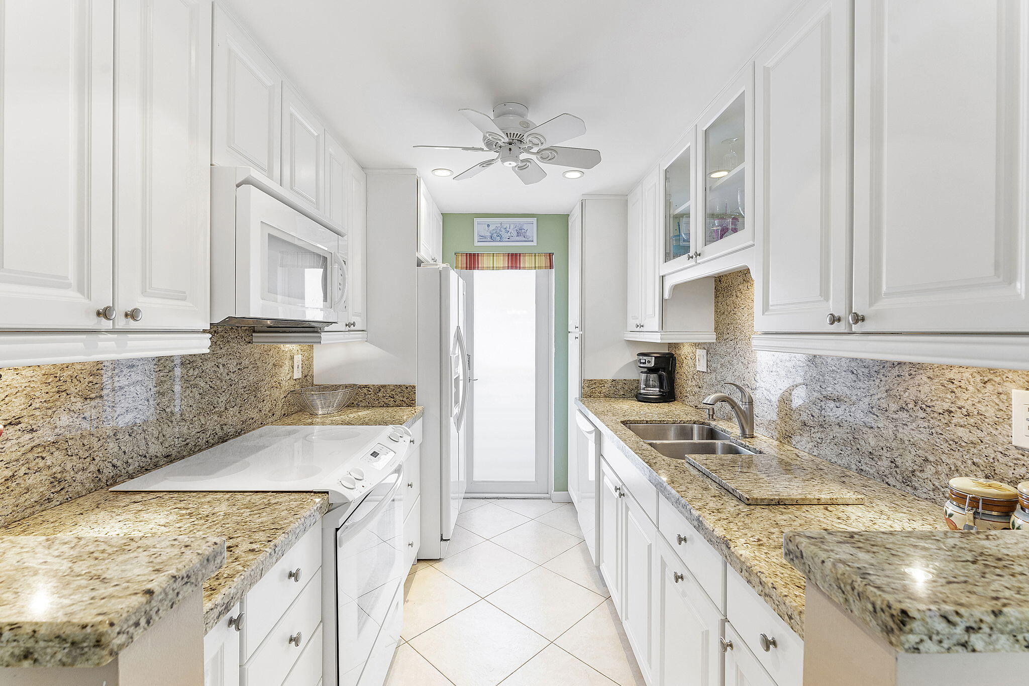 101 Northeast 19th Avenue, Unit 208 Deerfield Beach, FL 33441 - Photo 14 of 38 a kitchen with stainless steel appliances granite countertop a sink stove and refrigerator