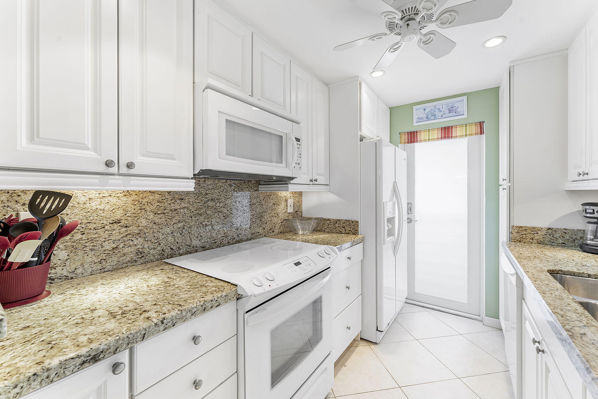 101 Northeast 19th Avenue, Unit 208 Deerfield Beach, FL 33441 - Photo 15 of 38 a kitchen with a sink stove and cabinets