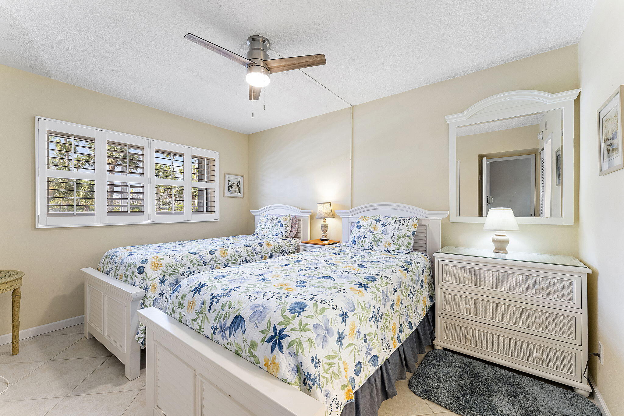 101 Northeast 19th Avenue, Unit 208 Deerfield Beach, FL 33441 - Photo 18 of 38 a bedroom with a bed and a dresser