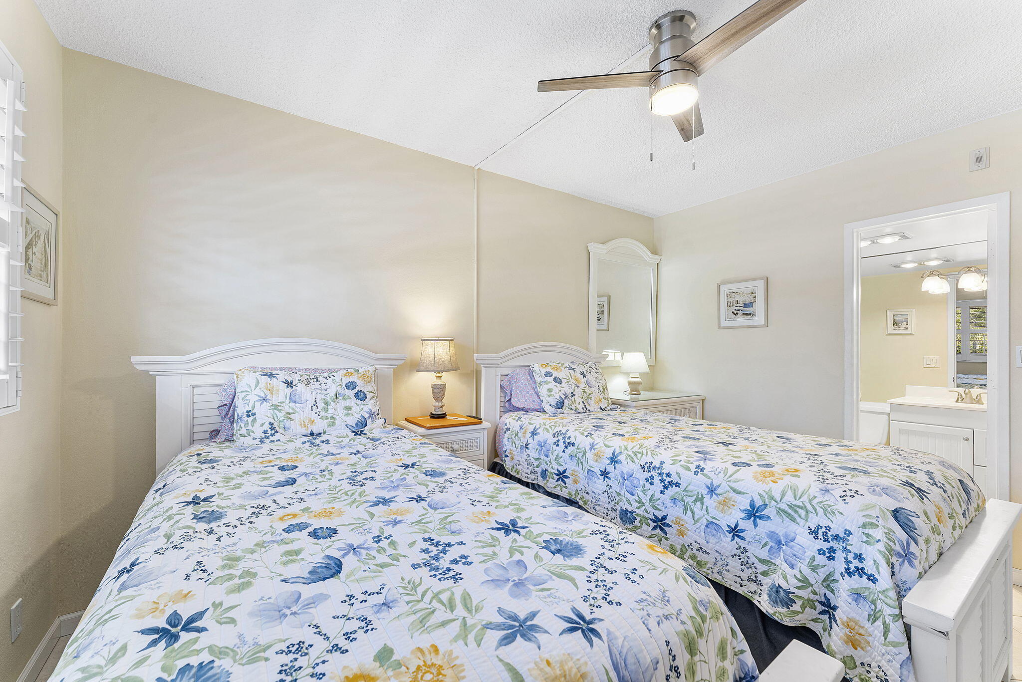 101 Northeast 19th Avenue, Unit 208 Deerfield Beach, FL 33441 - Photo 19 of 38 a bedroom with two large bed and a chandelier