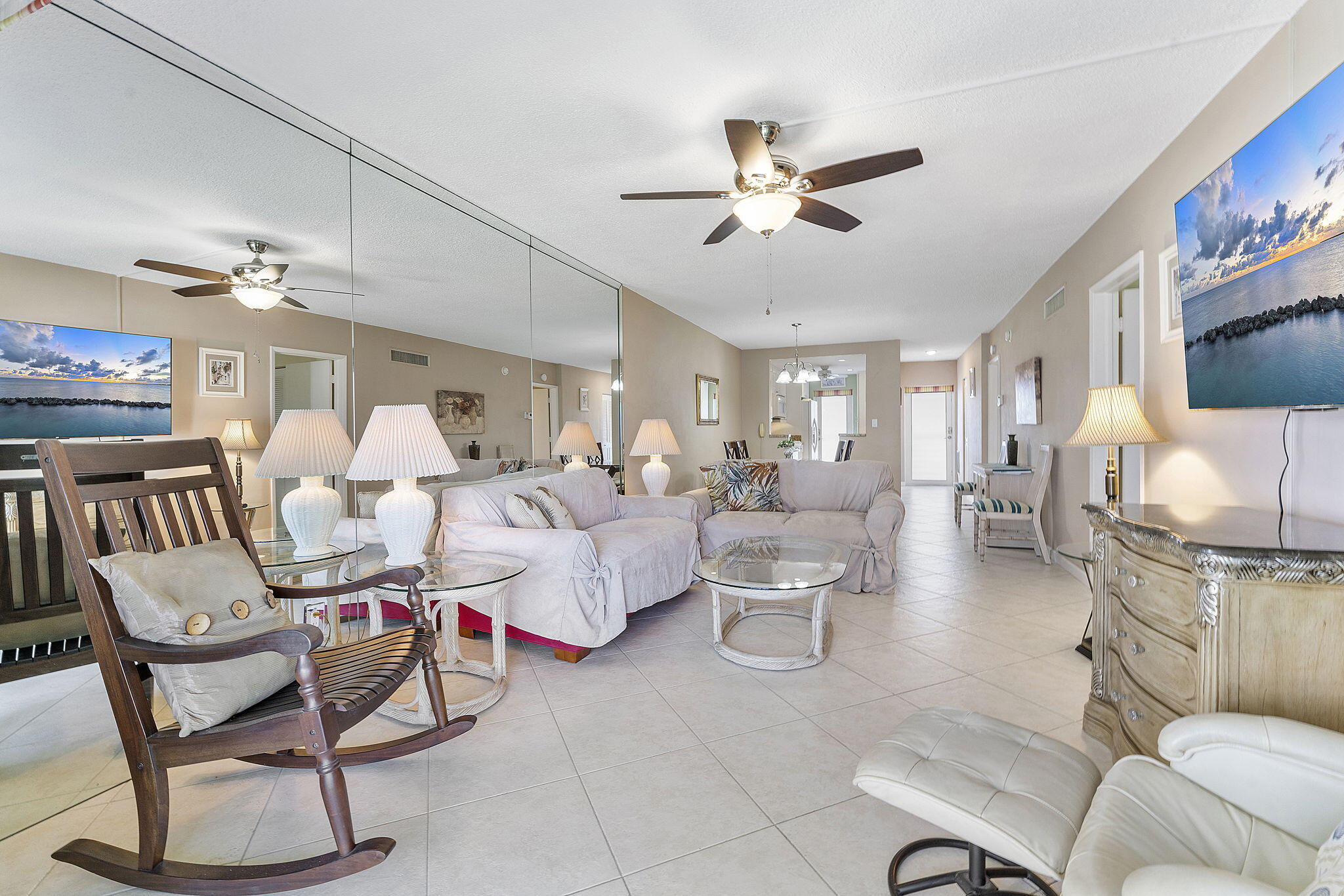 101 Northeast 19th Avenue, Unit 208 Deerfield Beach, FL 33441 - Photo 2 of 38 a living room with furniture and a chandelier