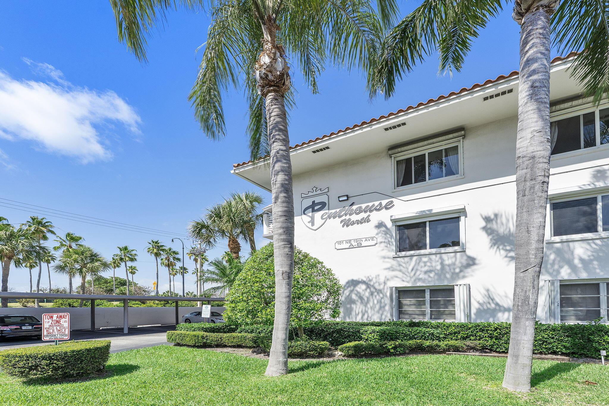 101 Northeast 19th Avenue, Unit 208 Deerfield Beach, FL 33441 - Photo 21 of 38 a view of a white house with a big yard plants and palm trees