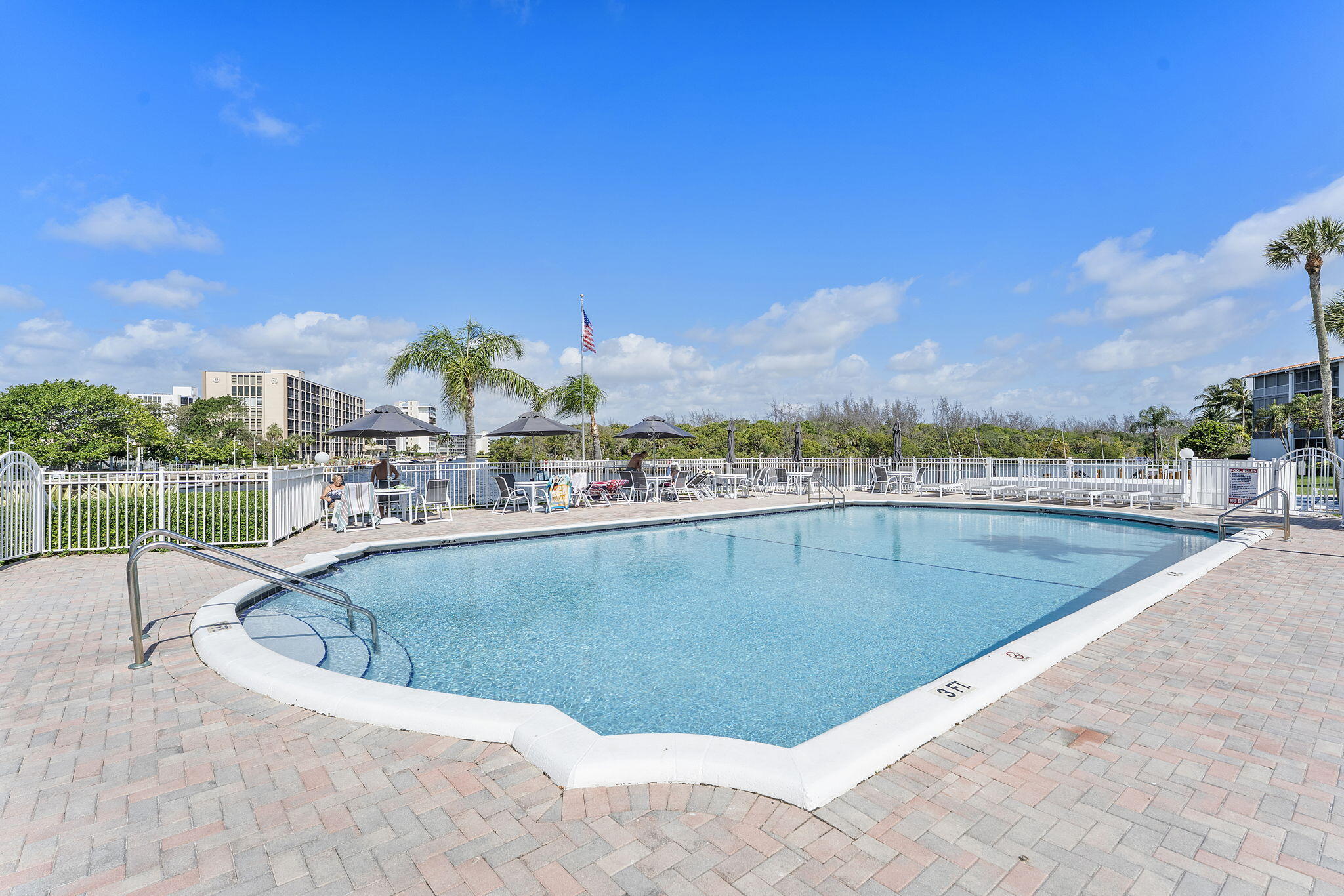 101 Northeast 19th Avenue, Unit 208 Deerfield Beach, FL 33441 - Photo 24 of 38 a view of a swimming pool and a terrace