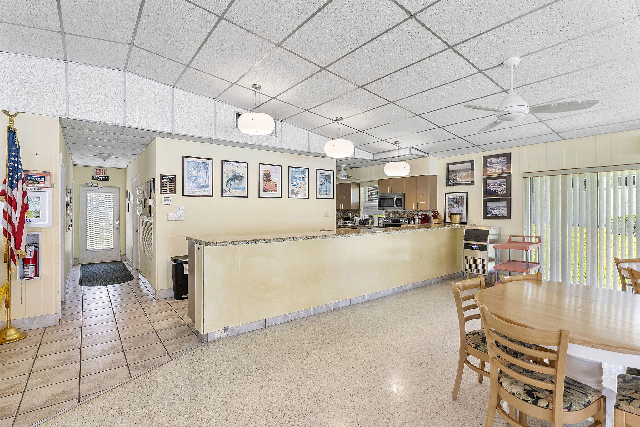 101 Northeast 19th Avenue, Unit 208 Deerfield Beach, FL 33441 - Photo 26 of 38 a hallway with a dining table chairs and entryway