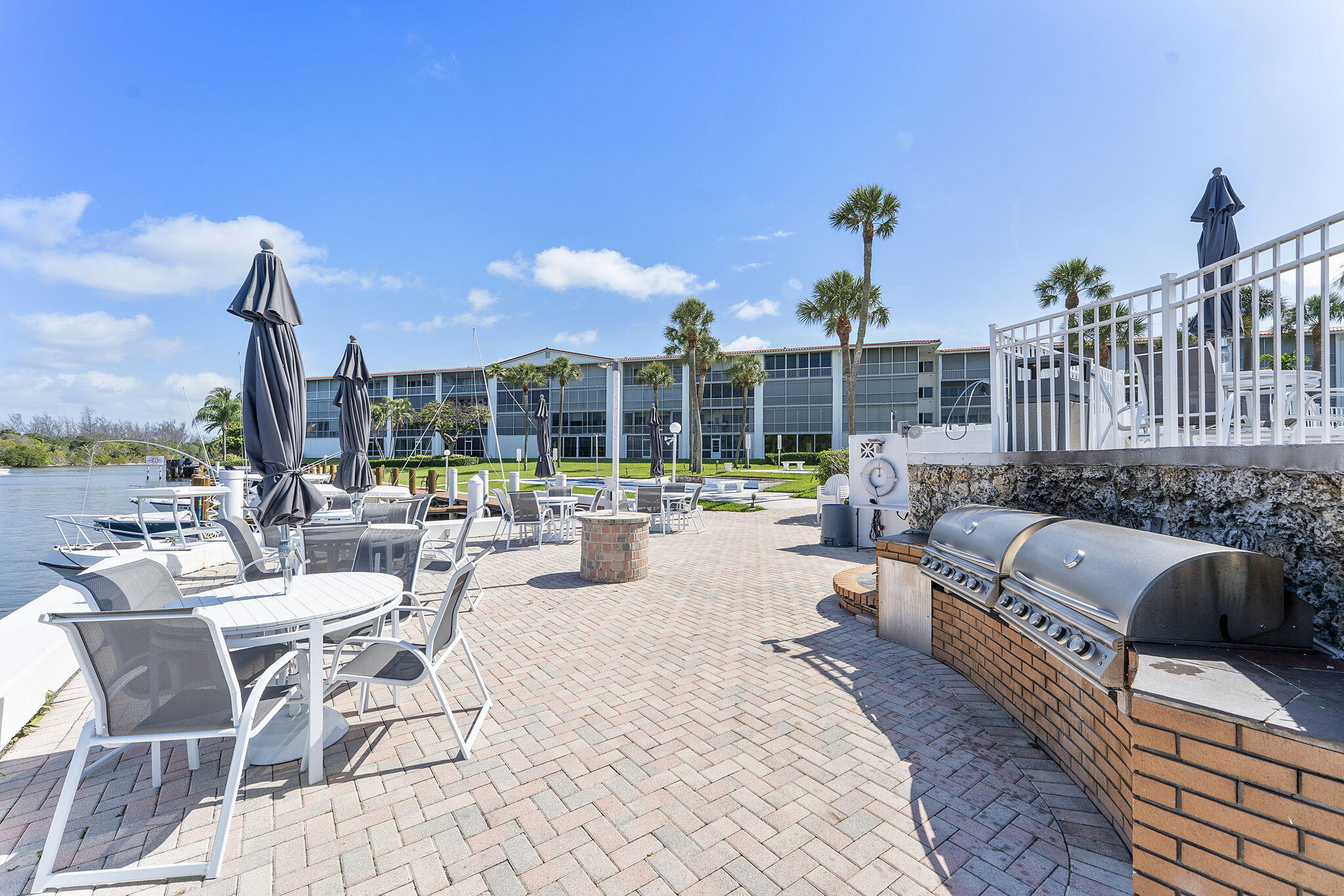 101 Northeast 19th Avenue, Unit 208 Deerfield Beach, FL 33441 - Photo 30 of 38 a view of a patio with couches and chairs