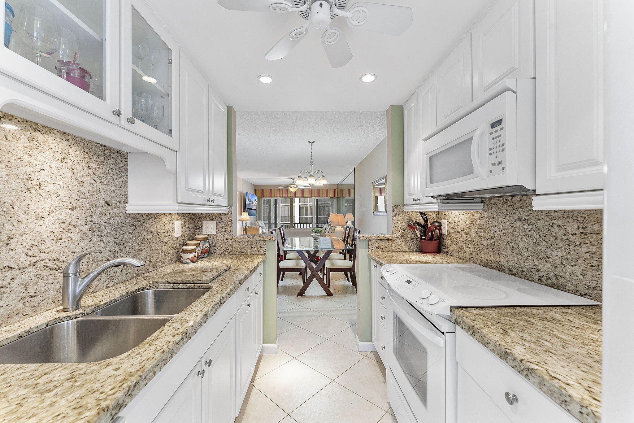 101 Northeast 19th Avenue, Unit 208 Deerfield Beach, FL 33441 - Photo 3 of 38 a kitchen with stainless steel appliances granite countertop a sink stove and cabinets