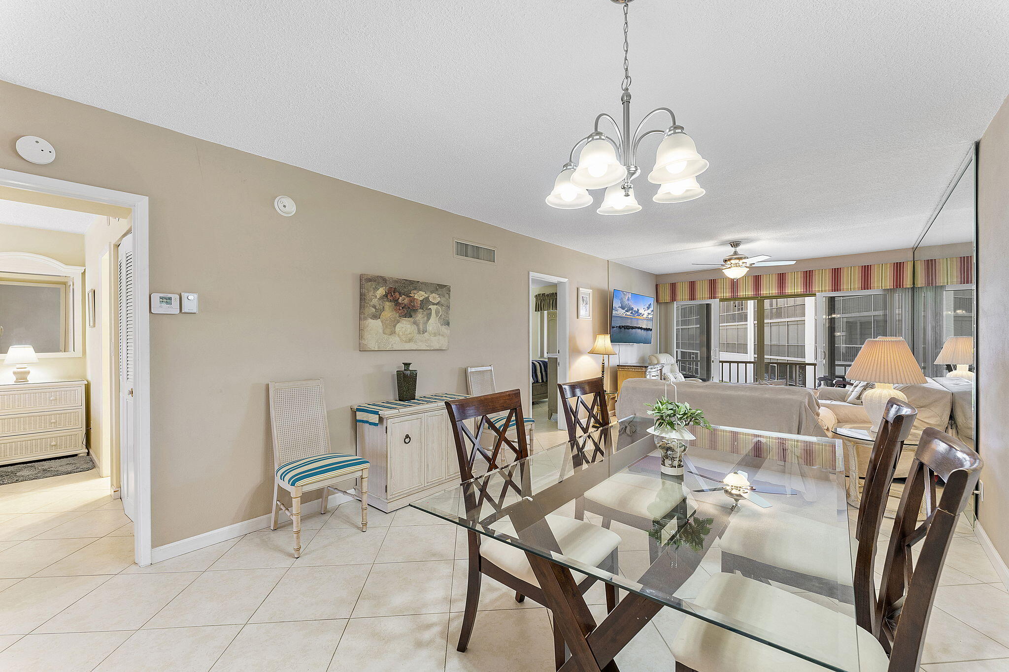 101 Northeast 19th Avenue, Unit 208 Deerfield Beach, FL 33441 - Photo 6 of 38 a view of a dining room with furniture wooden floor and chandelier