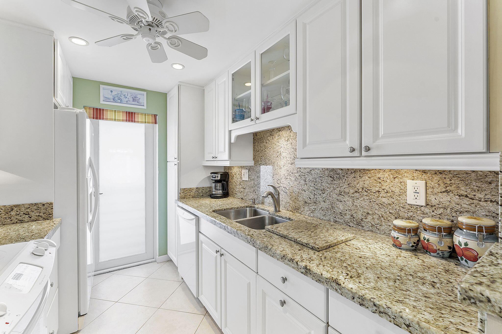 101 Northeast 19th Avenue, Unit 208 Deerfield Beach, FL 33441 - Photo 7 of 38 a kitchen with granite countertop a sink stainless steel appliances and cabinets