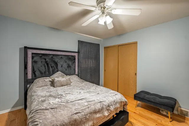 a bedroom with a bed and a chandelier