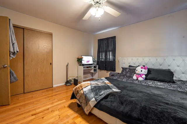 a bedroom with a bed and wooden floor