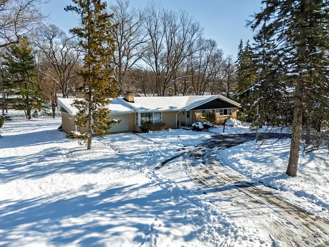 a view of a house with yard and sitting area