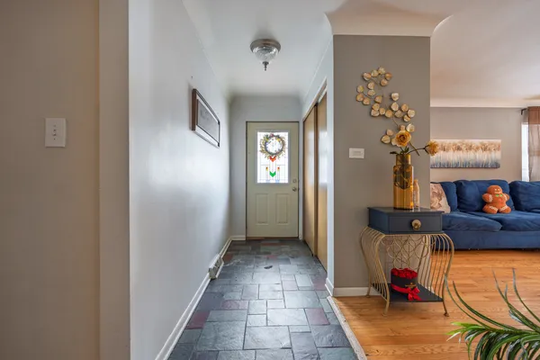 a view of a hallway to a livingroom and a dining room with furniture
