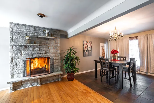 a dining room with furniture entryway and wooden floor